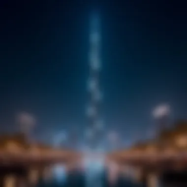 Night view of the tower illuminated, representing its impact on Dubai's nightlife and tourism.